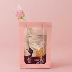 Gift bag with product packaging on a pink background